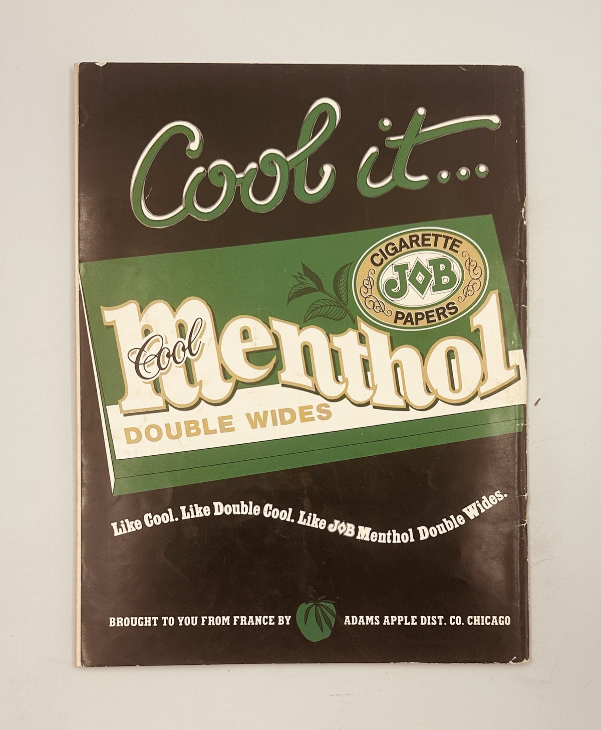 Cover of J.O.B Menthol Double Wides cigarette papers featuring the slogan 'Cool it... Cool Menthol Double Wides,' highlighting the product branding with a vintage design aesthetic.