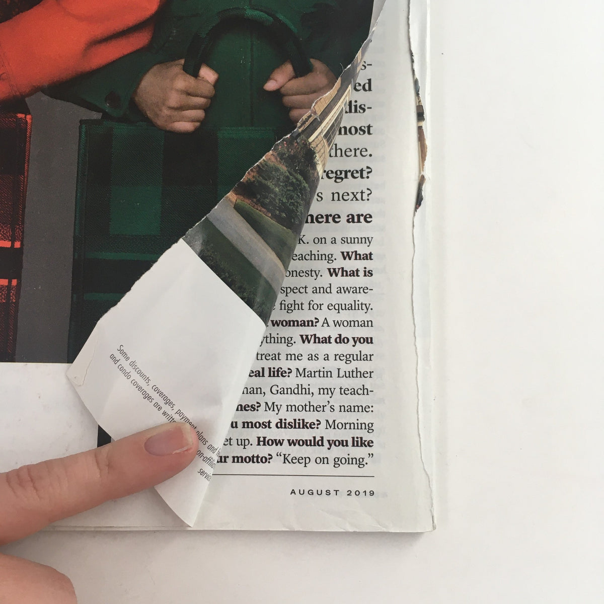Close-up of the corner of the Vanity Fair Magazine August 2019, featuring a finger pointing at text, showcasing the condition of this vintage magazine, which includes slight wear and a small rip on the back cover, reinforcing its collectibility.