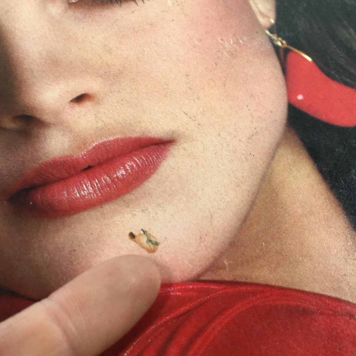 Detailed inspection of Vintage Vogue Magazine May 1981 cover, showcasing Brooke Shields, focusing on a minor blemish near the model's chin.