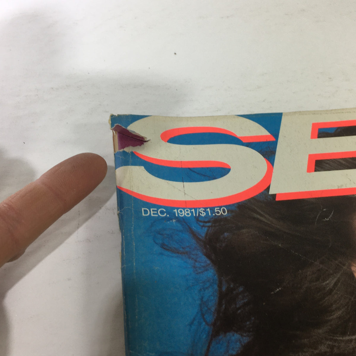 Close-up of damaged corner of Vintage Self Magazine from December 1981, highlighting wear and tear typical of a collectible item.