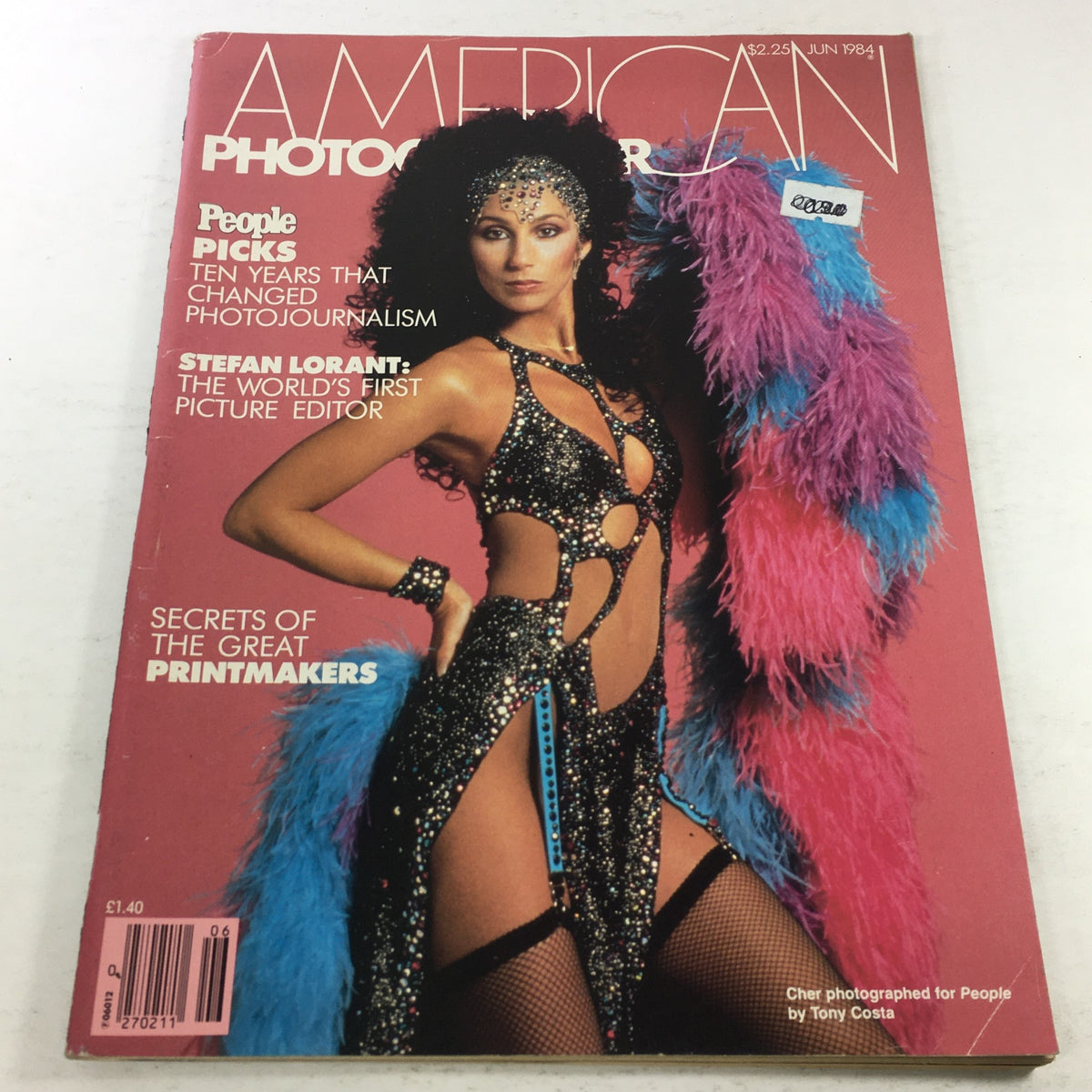 Vintage American Photographer magazine cover from June 1984 featuring Cher photographed by Tony Costa, showcasing Cher in a glamorous costume with colorful feathers.