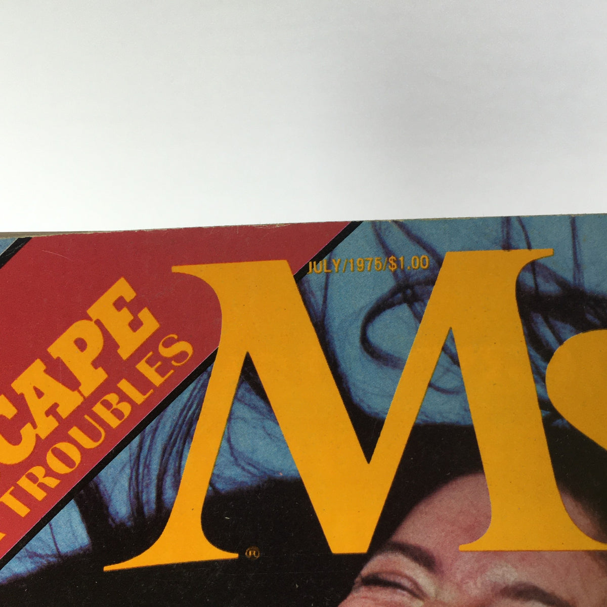 Close-up of the title and date of the Vintage Ms. Magazine, July 1975, showcasing the bold text 'Ms.' and price information.