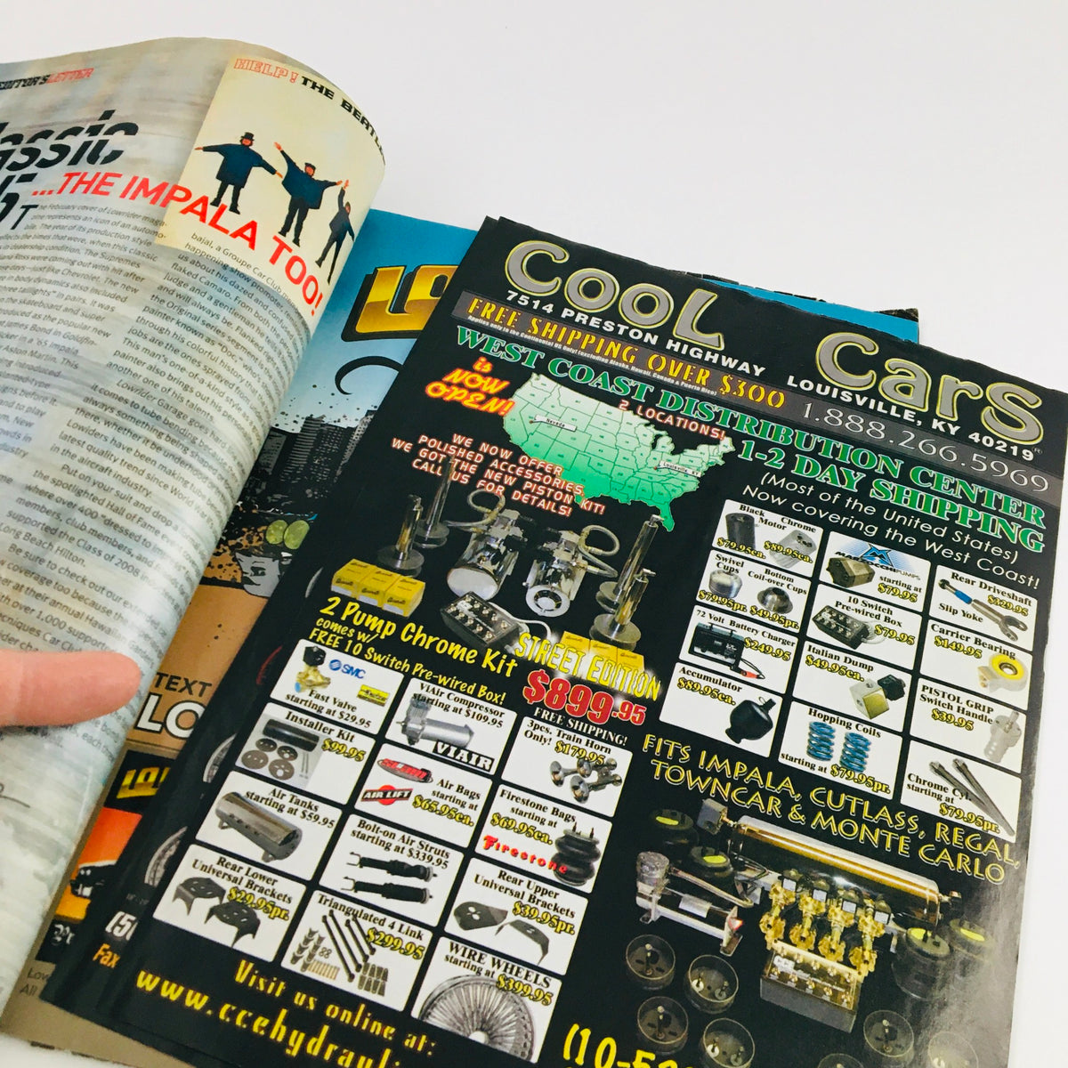 Inside spread of LowRider Magazine February 2009 showcasing advertisements and content related to Cool Cars and automotive accessories.