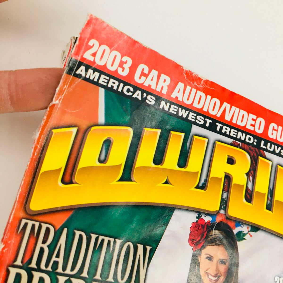 Close-up of the top corner of the LowRider Magazine May 2003 showcasing the slogan '2003 Car Audio/Video Guide'.