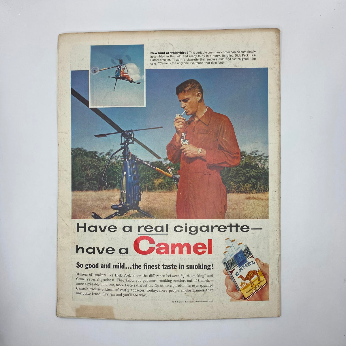 Advertisement page from the Saturday Evening Post Magazine February 1, 1958 promoting Camel cigarettes, featuring a man with a helicopter, and text emphasizing the quality of Camel cigarettes.