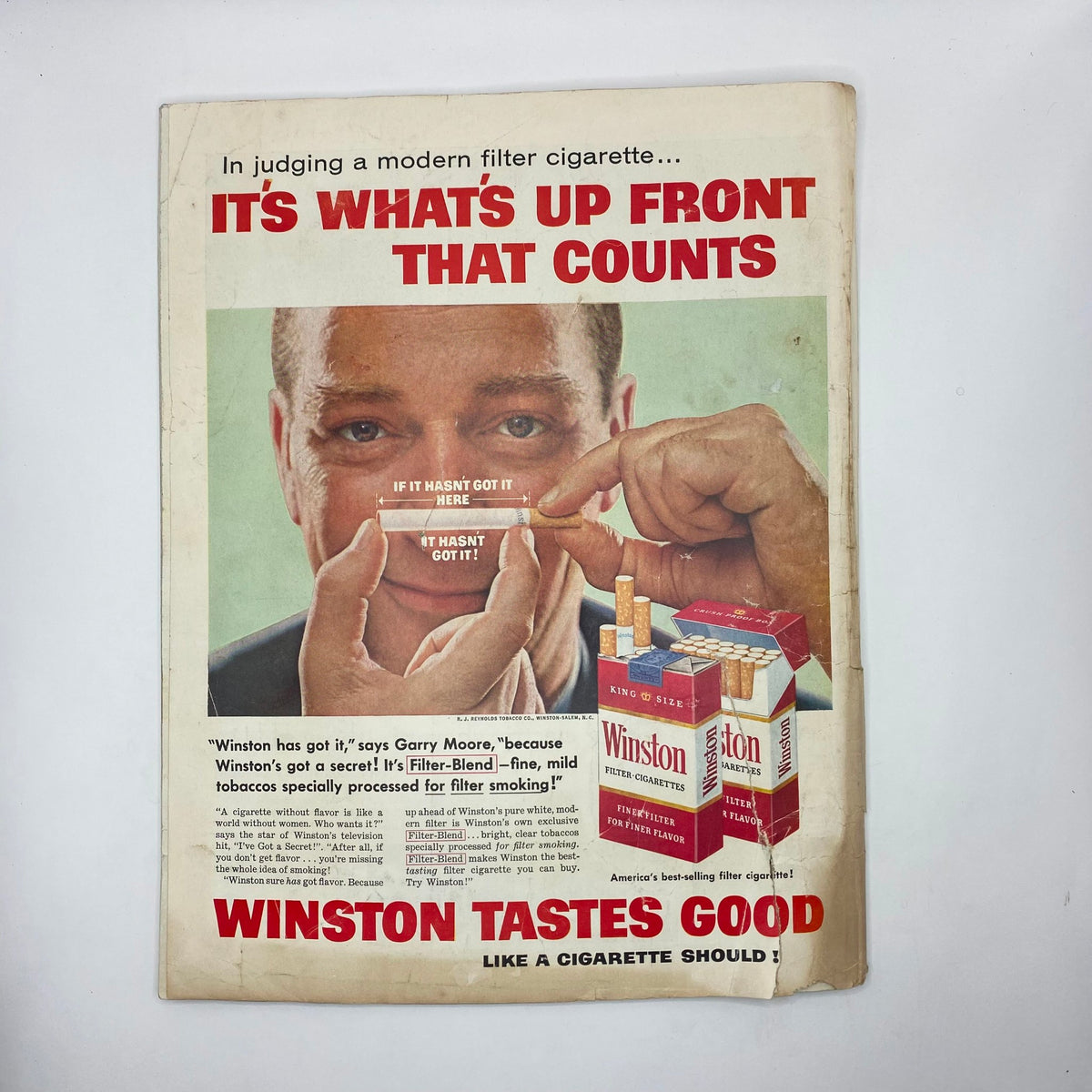 Advertisement page in Saturday Evening Post Magazine October 11, 1958 promoting Winston cigarettes with a striking visual of a man holding a cigarette, exemplifying vintage advertising tactics.