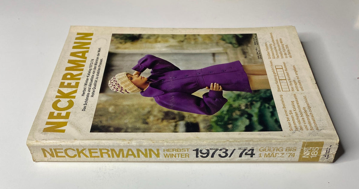 Side view of the 1973-1974 Neckermann Winter Catalog featuring a model in a purple coat and knitted hat, emphasizing the vintage winter styles presented in the catalog.