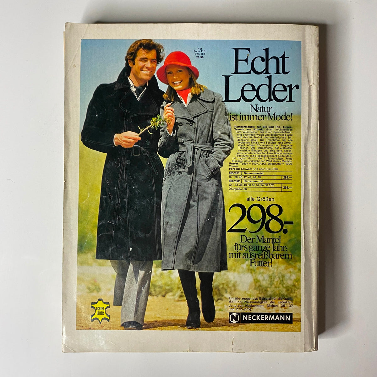 The cover of the 1976-1977 February Neckermann Winter Catalog featuring a man and woman in fashionable outerwear, promoting winter fashion trends.