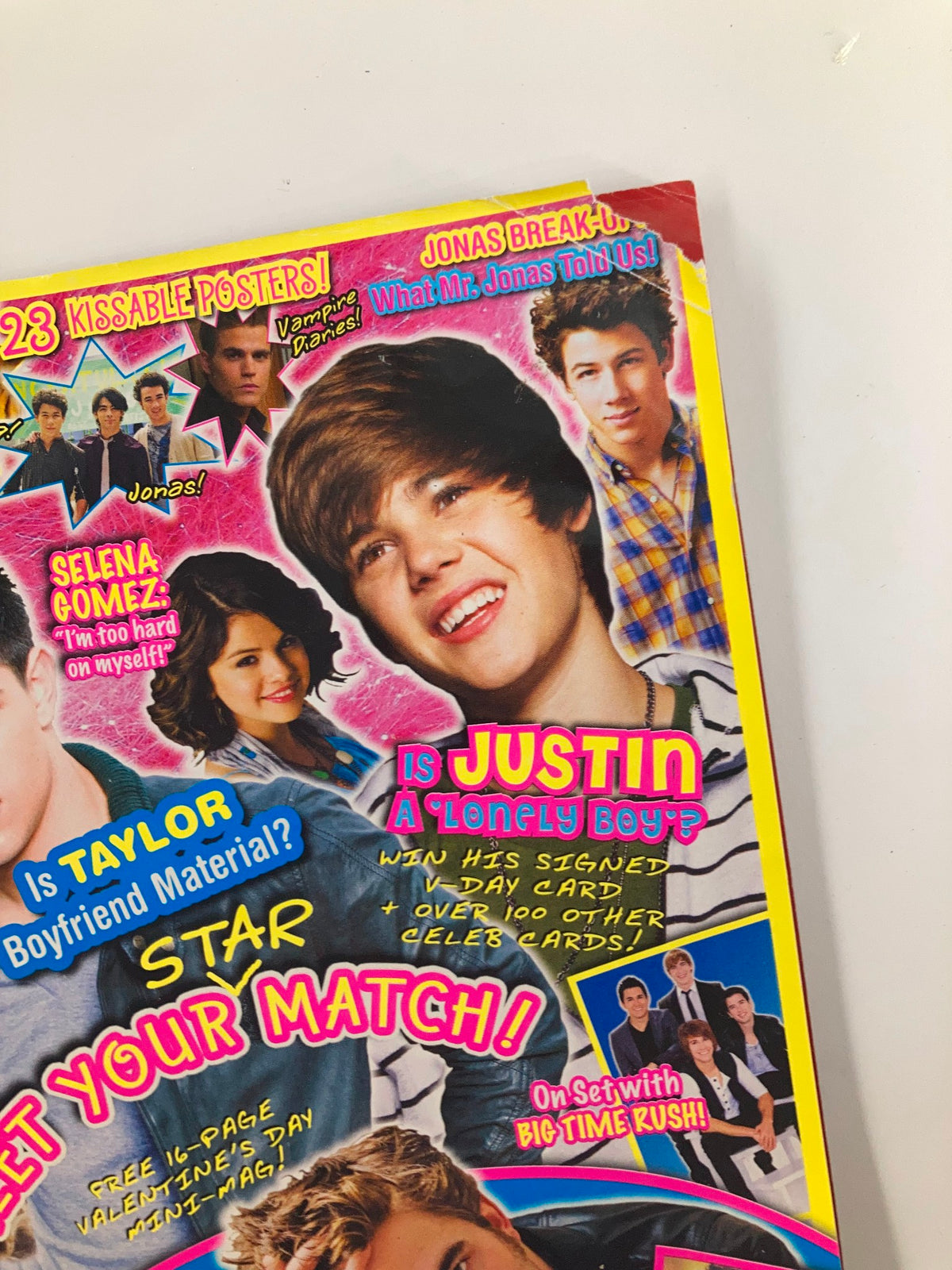 Close-up of Pop Star Magazine February 2010 highlighting Justin Bieber, with eye-catching text and images of celebrity gossip.