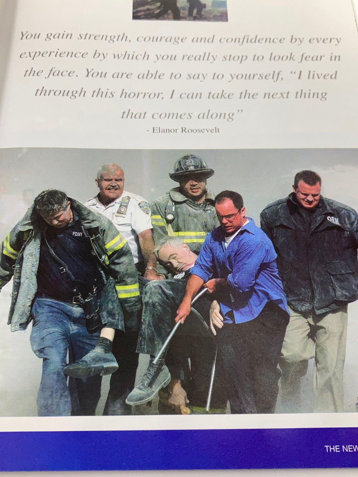 September 11 2001 Standing Strong: The Spirit of New York - A photo showing emergency personnel carrying a survivor to safety amidst the chaos and destruction of the September 11 attacks.