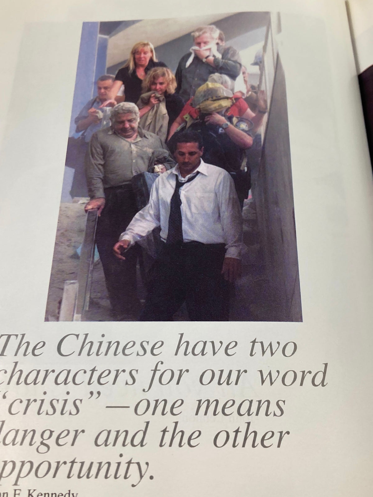 Photograph showing survivors following the September 11 attacks, emphasizing human spirit and determination, featured in 'September 11 2001 Standing Strong: The Spirit of New York'.
