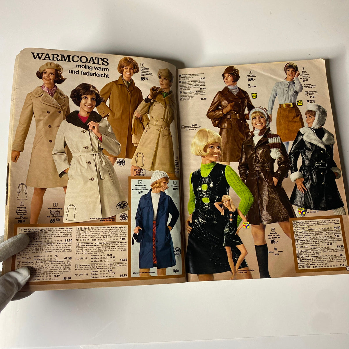 An elegant page from the 1973 Neckermann Summer Catalog showcasing a variety of warm coats, featuring stylish models in different coats and accessories, perfect for vintage fashion enthusiasts.