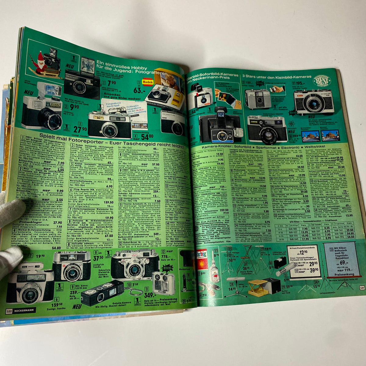 Page from the 1973 Neckermann Summer Catalog displaying various cameras and photographic equipment available for purchase, with price listings.