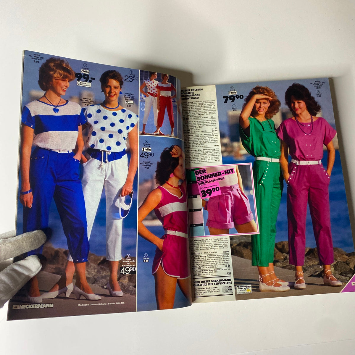 Open pages of the 1983 Neckermann Summer Catalog displaying fashionable outfits including polka dot tops and shorts, illustrating popular styles for summer wear in the early 80s.