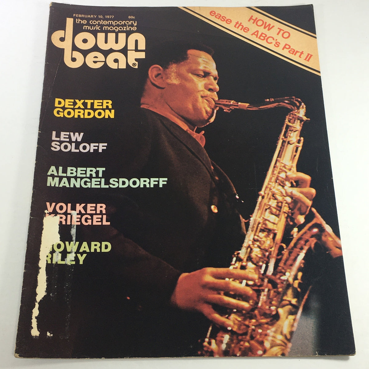 Cover of Down Beat Magazine dated February 10, 1977, featuring Dexter Gordon on saxophone, with additional names including Lew Soloff, Albert Mangelsdorff, Volker Riegel, and Howard Riley. This vintage magazine highlights the jazz scene of the late 1970s.