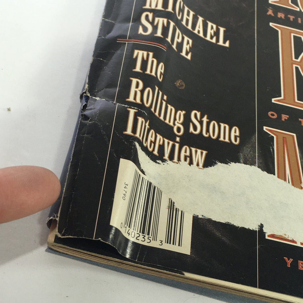 Close-up view of the damaged edge of the Rolling Stone magazine cover featuring Michael Stipe's interview from March 5, 1992.