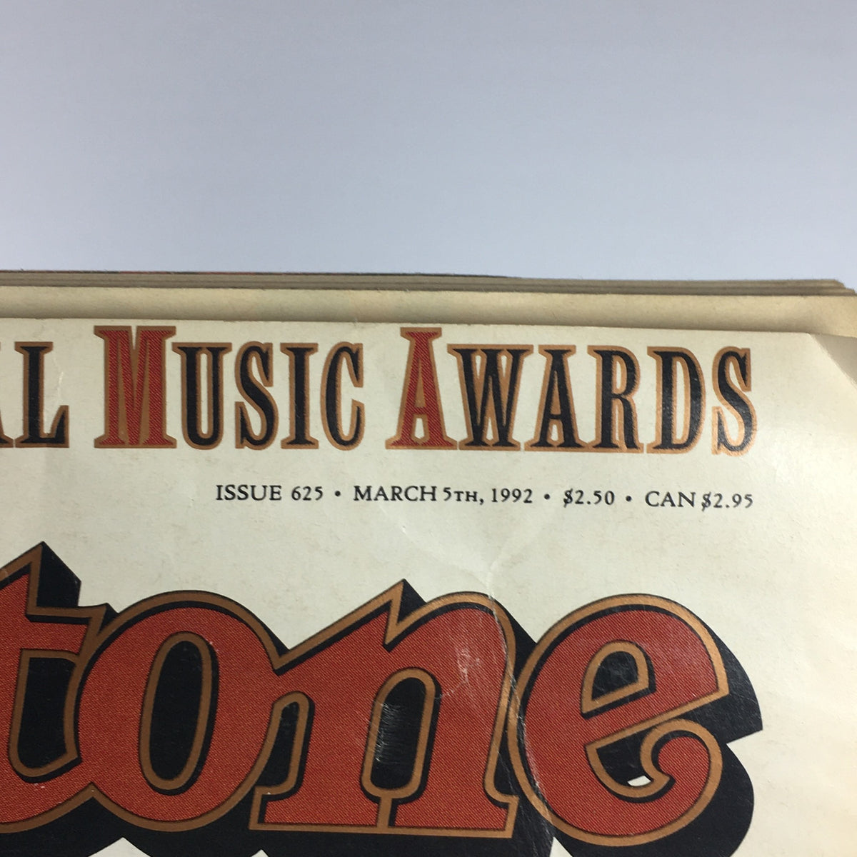 Top section of the Rolling Stone magazine from March 5, 1992, highlighting the issue number and details about the Music Awards.
