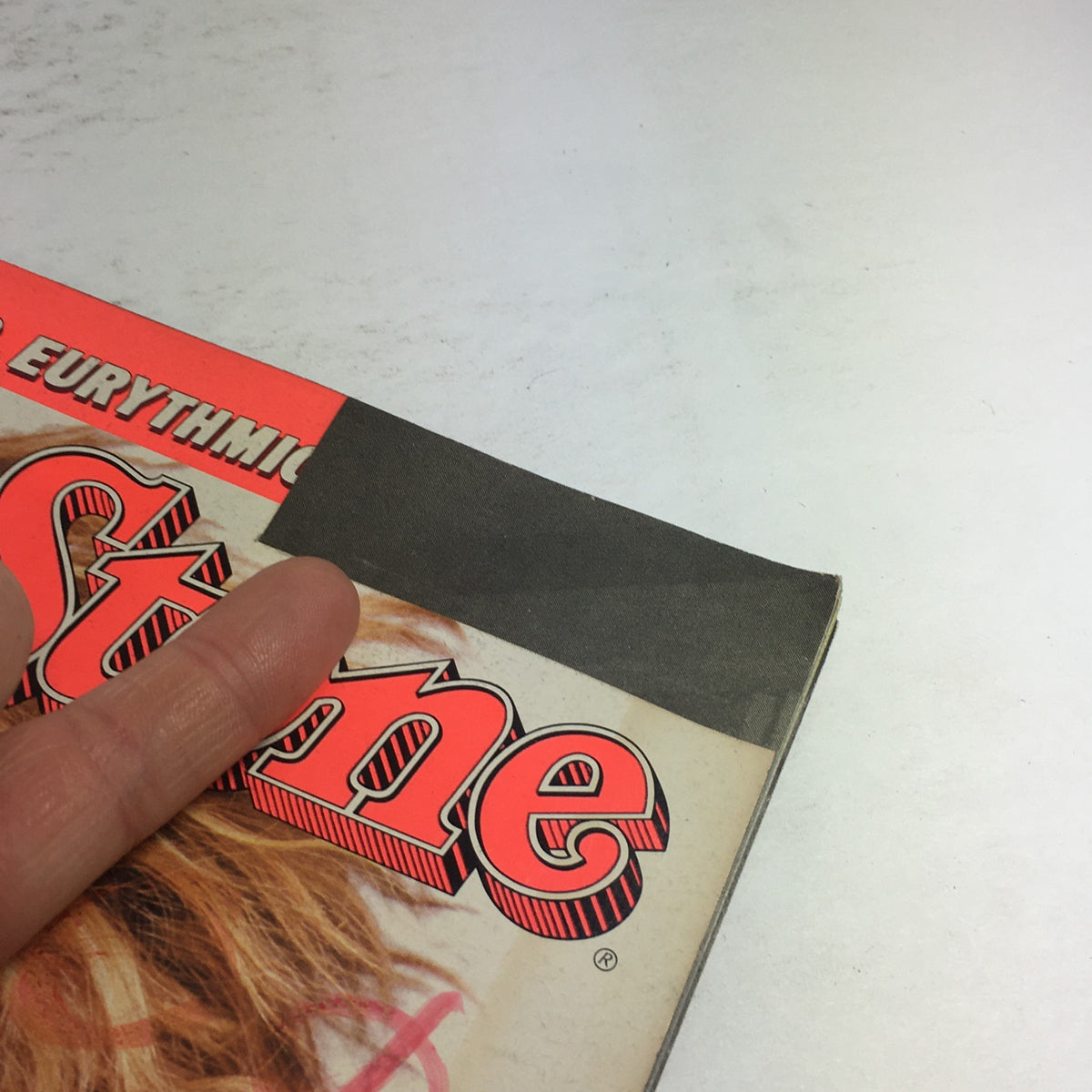 Close-up of the side edge of the Rolling Stone Magazine: October 23 1986, showing minor wear and the magazine's title with Tina Turner.
