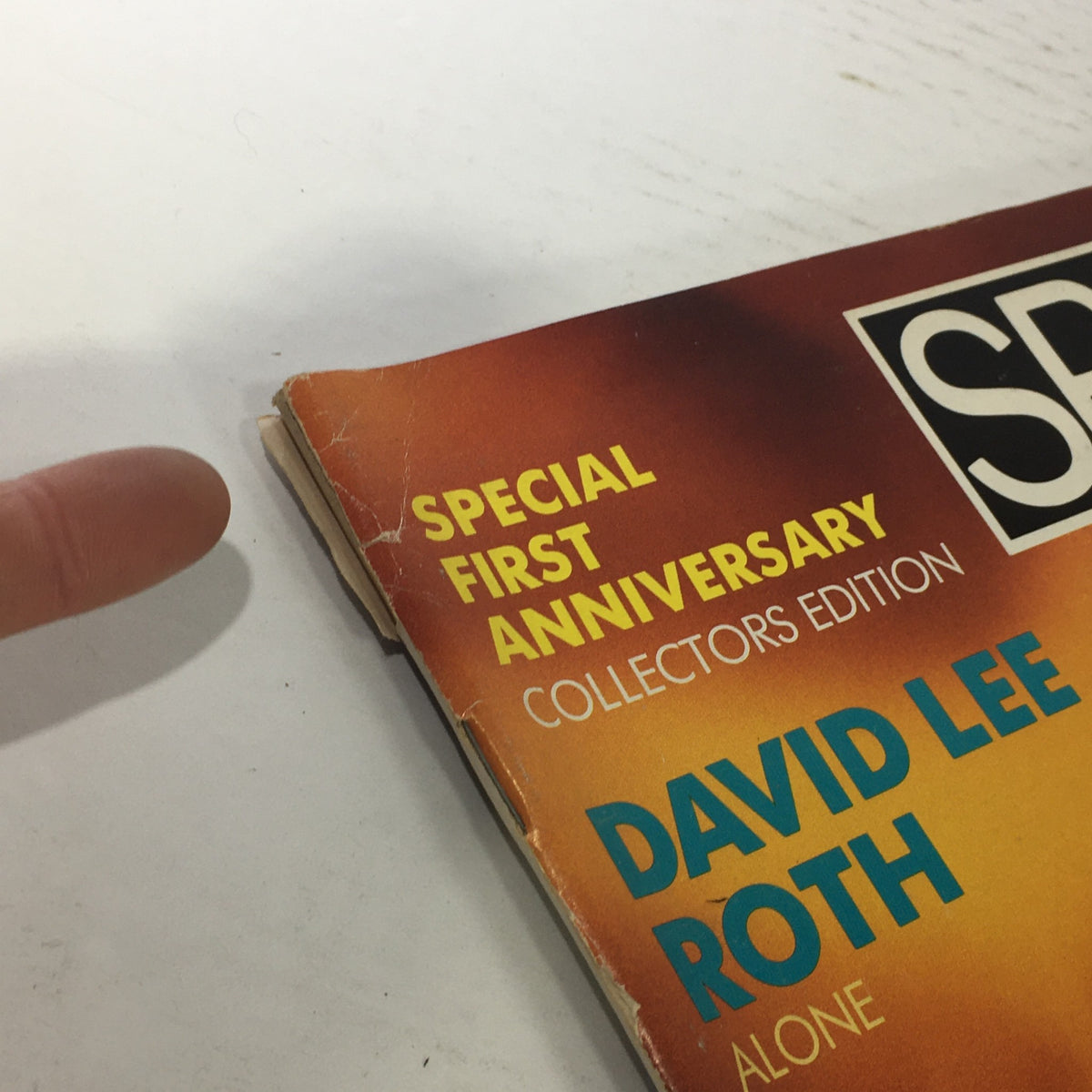 Close-up of the cover of VTG Spin Magazine from April 1986 featuring David Lee Roth, highlighting the 'Special First Anniversary' and 'Collectors Edition' text, showing signs of wear.