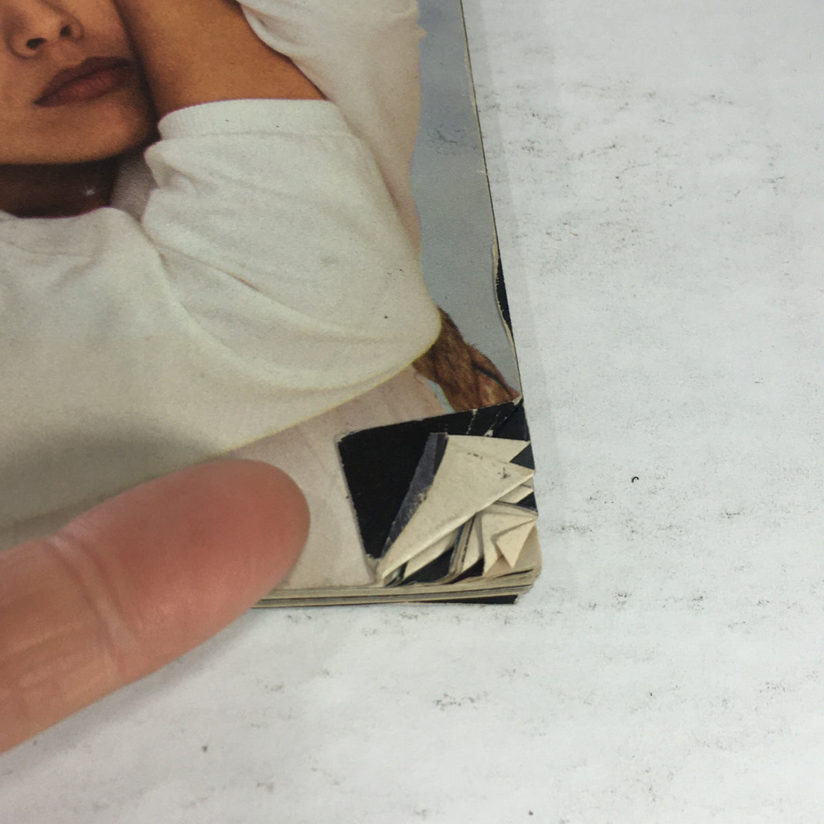 Close-up view of the damaged corner of the vintage Esquire Magazine April 1985, showcasing wear and tear indicative of its collectible nature.