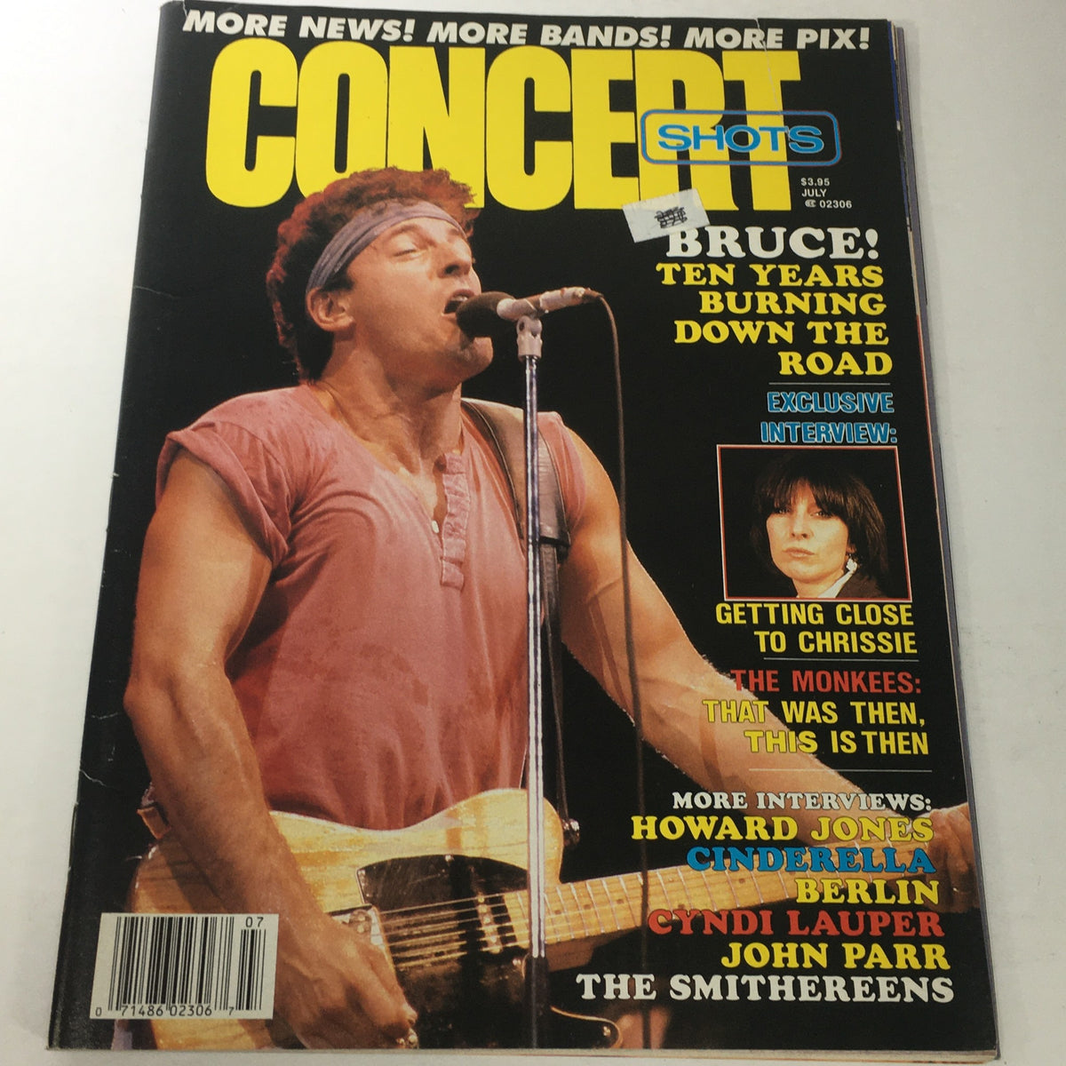 Cover of VTG Concert Shots Magazine: Vol. 2 #6 July 1987 featuring a vibrant photo of a male artist performing live, capturing the energy of the 80s music scene. The magazine showcases Cyndi Lauper, John Parr, and more, emphasizing its collectible nature for vintage music enthusiasts.
