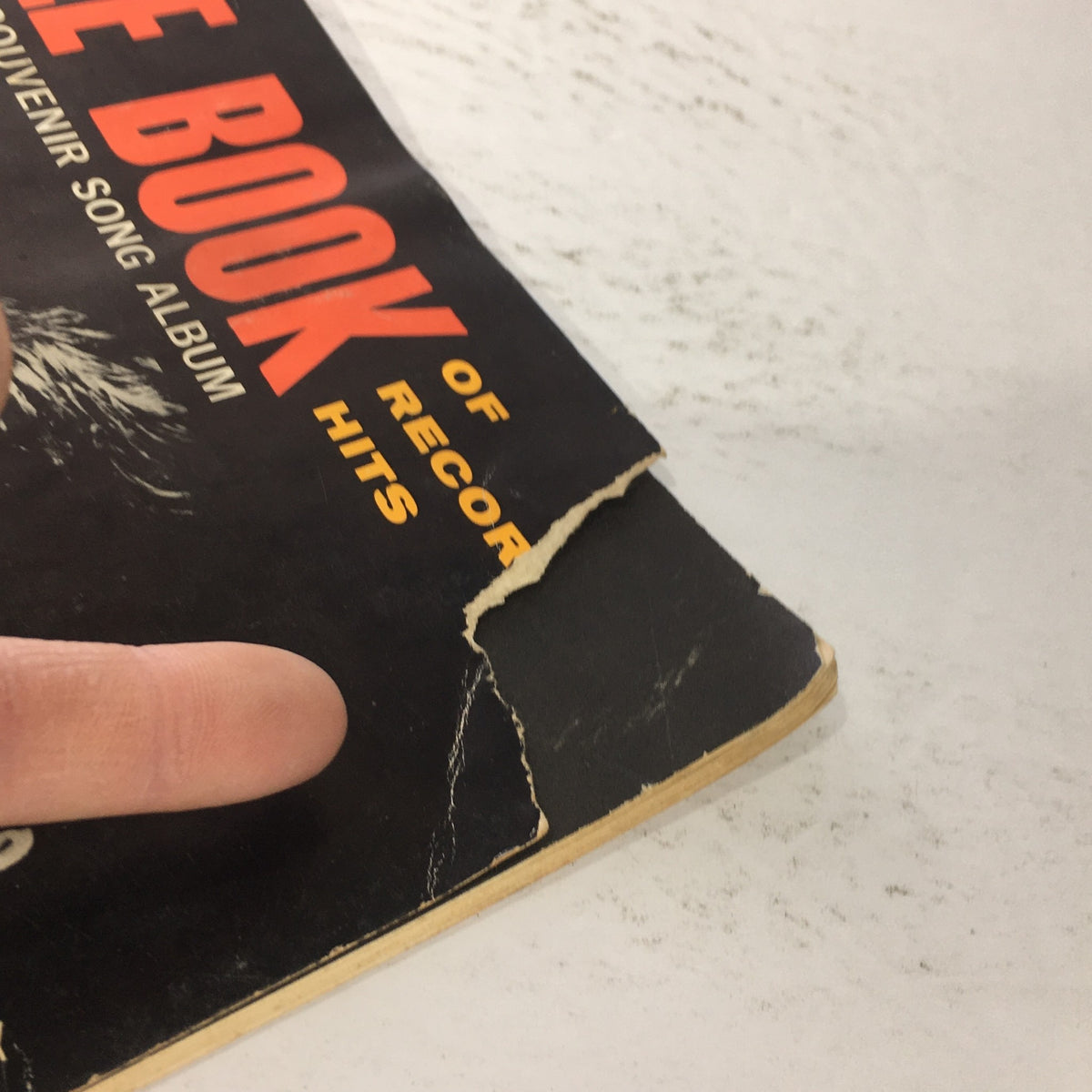 Close-up of the edge of the VTG The Beatle Book Souvenir Song Album showing signs of wear and tear, highlighting its vintage charm.