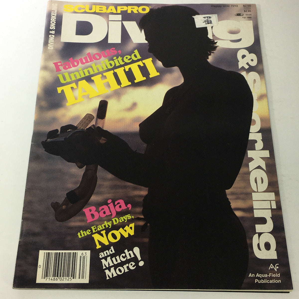 Cover of VTG Scubapro Diving & Snorkeling Magazine: Fall 1986 - Uninhibited Tahiti featuring underwater imagery and bold text highlighting Tahiti. The magazine showcases a silhouette figure holding snorkeling gear against a scenic background.