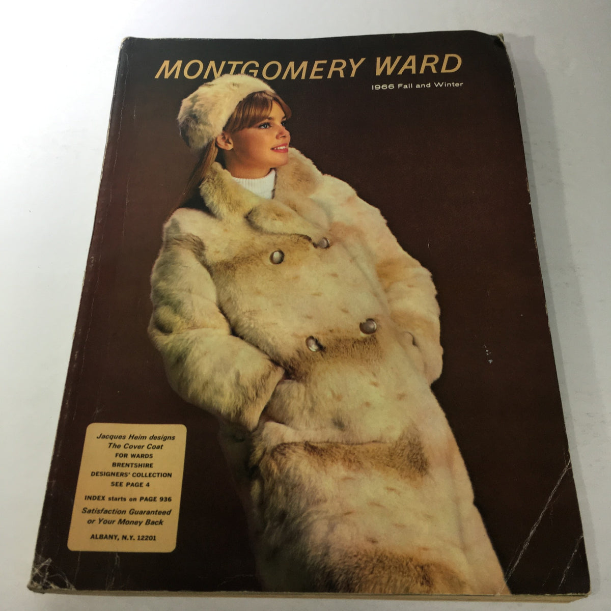 VTG Montgomery Ward catalog: Fall & Winter 1966 featuring a winter coat collection. The cover displays a model wearing a stylish faux fur coat and matching hat, showcasing vintage fashion trends.