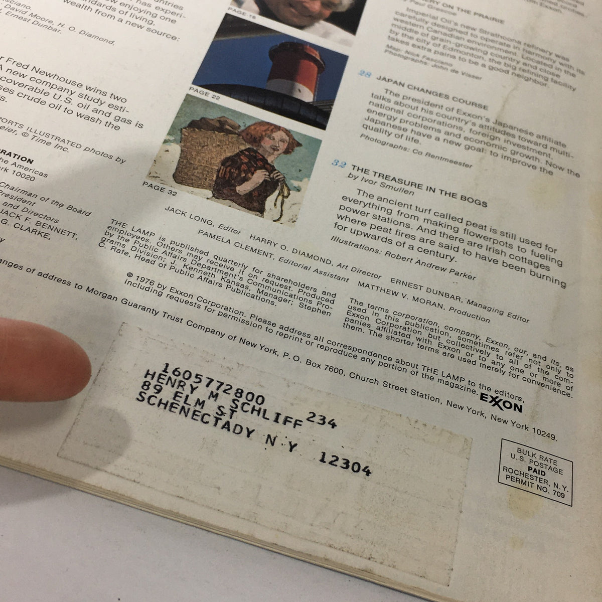 The Lamp Magazine Winter 1976 back cover featuring editorial details, including article titles such as 'Japan Changes Course' and 'The Treasure in the Bogs', along with an address label belonging to Henry M. Schliff from Schenectady, N.Y.