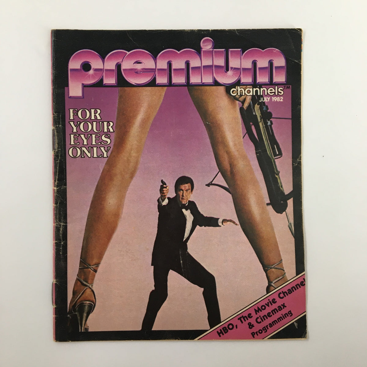 Cover of the VTG Premium Channels Mini Magazine from July 1982 featuring a striking graphic design with the title 'FOR YOUR EYES ONLY' and Roger Moore as James Bond aiming a gun.