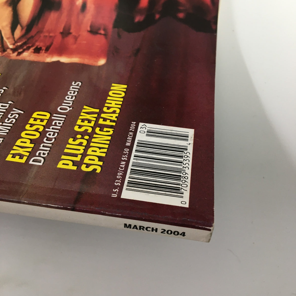 Side view of VIBE Magazine March 2004 edition, displaying the issue's bar code and listing of featured content including Alicia Keys, with a label indicating minor wear.