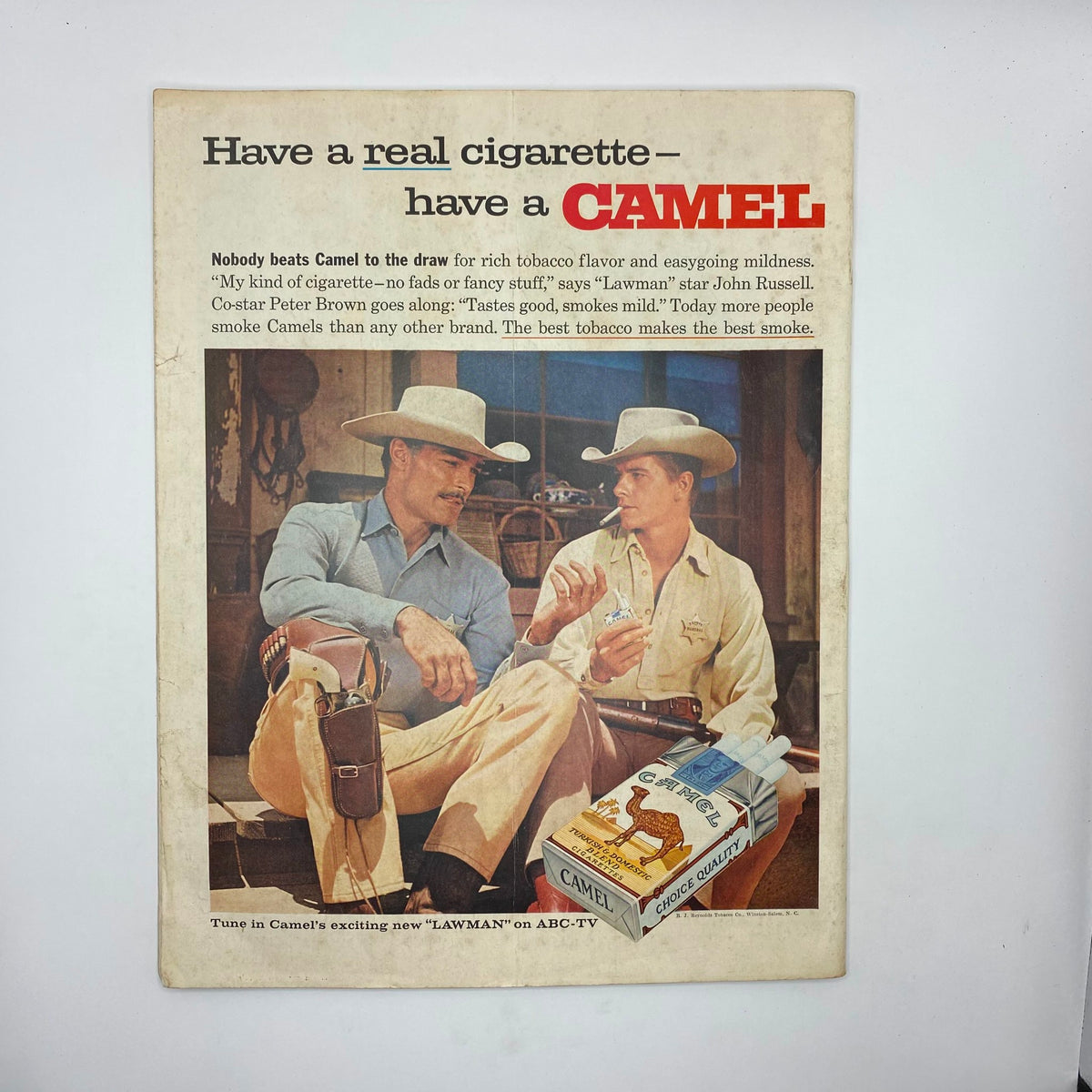 Advertisement from the Saturday Evening Post Magazine, March 28, 1959, featuring two cowboys promoting Camel cigarettes, with a call to action regarding their flavor and smoothness.