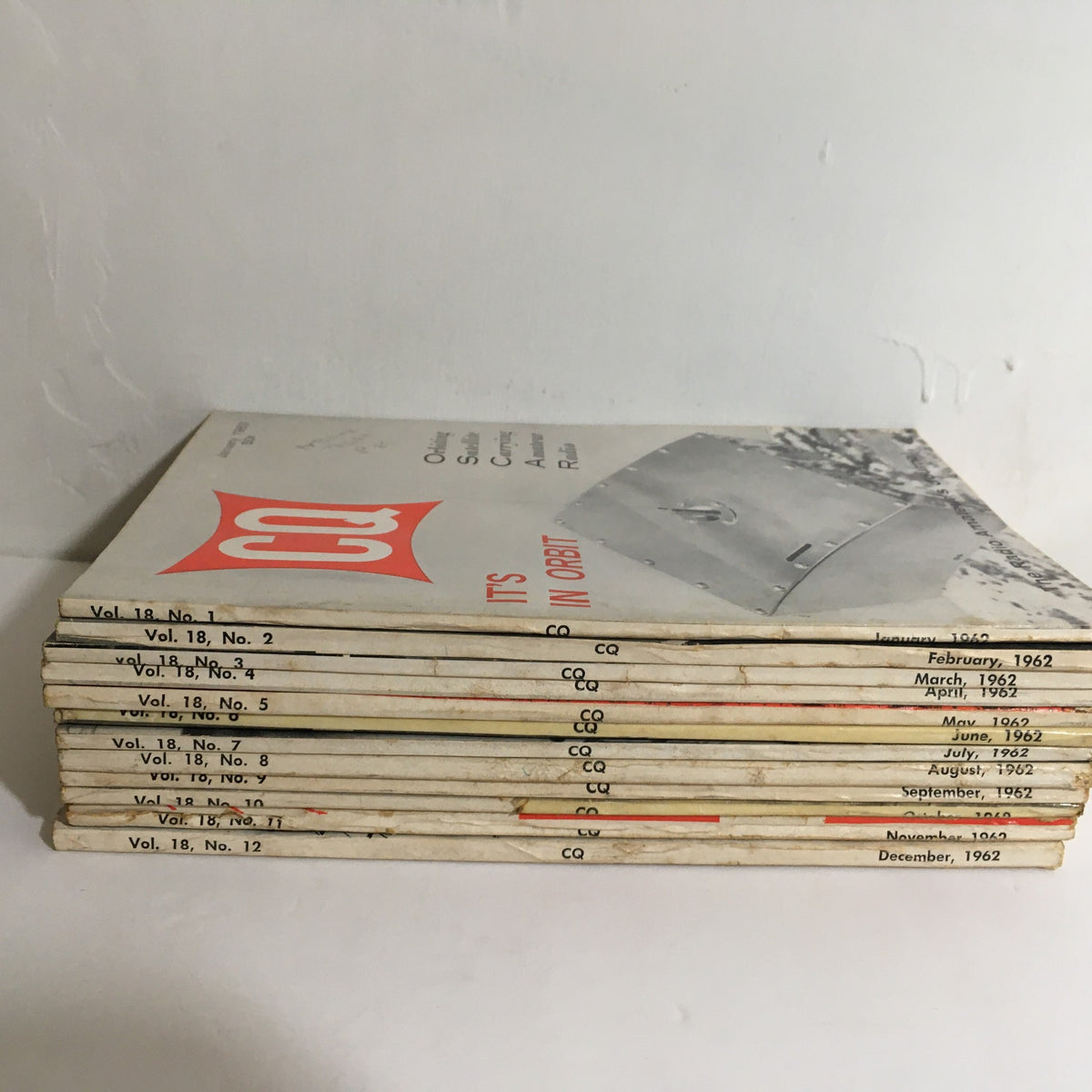 Stack of 12 issues from January to December 1962 of CQ The Radio Amateur's Journal, highlighting historical content on amateur radio.