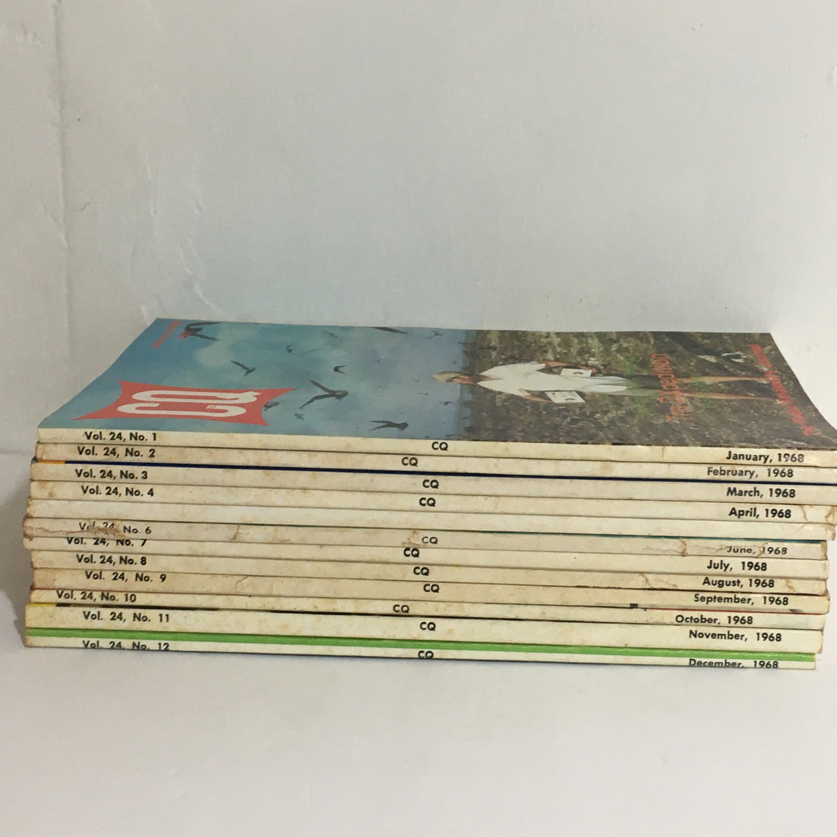 Lot of 12 Complete January to December 1968 CQ The Radio Amateur's Journal - Side view of the stacked magazines showing monthly issues from January to December with identifiable volume details.