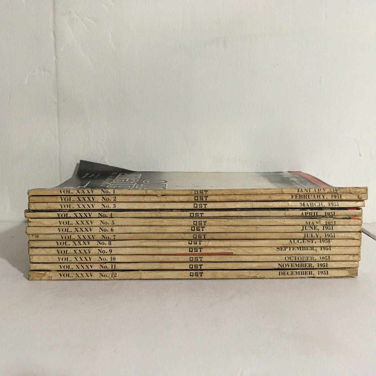 Lot of 12 Complete January to December 1951 QST Amateur Radio magazines stacked neatly displaying the volume and issue numbers for 1951.