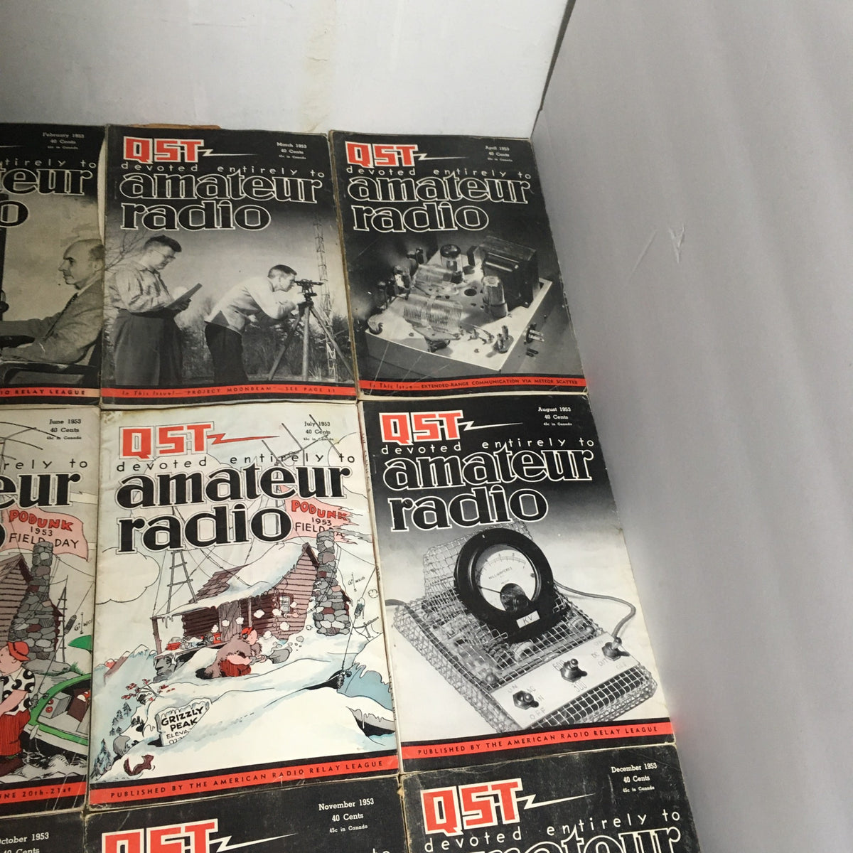 Lot of 12 Complete January to December 1953 QST Amateur Radio magazines displayed showcasing various covers from February to May 1953.