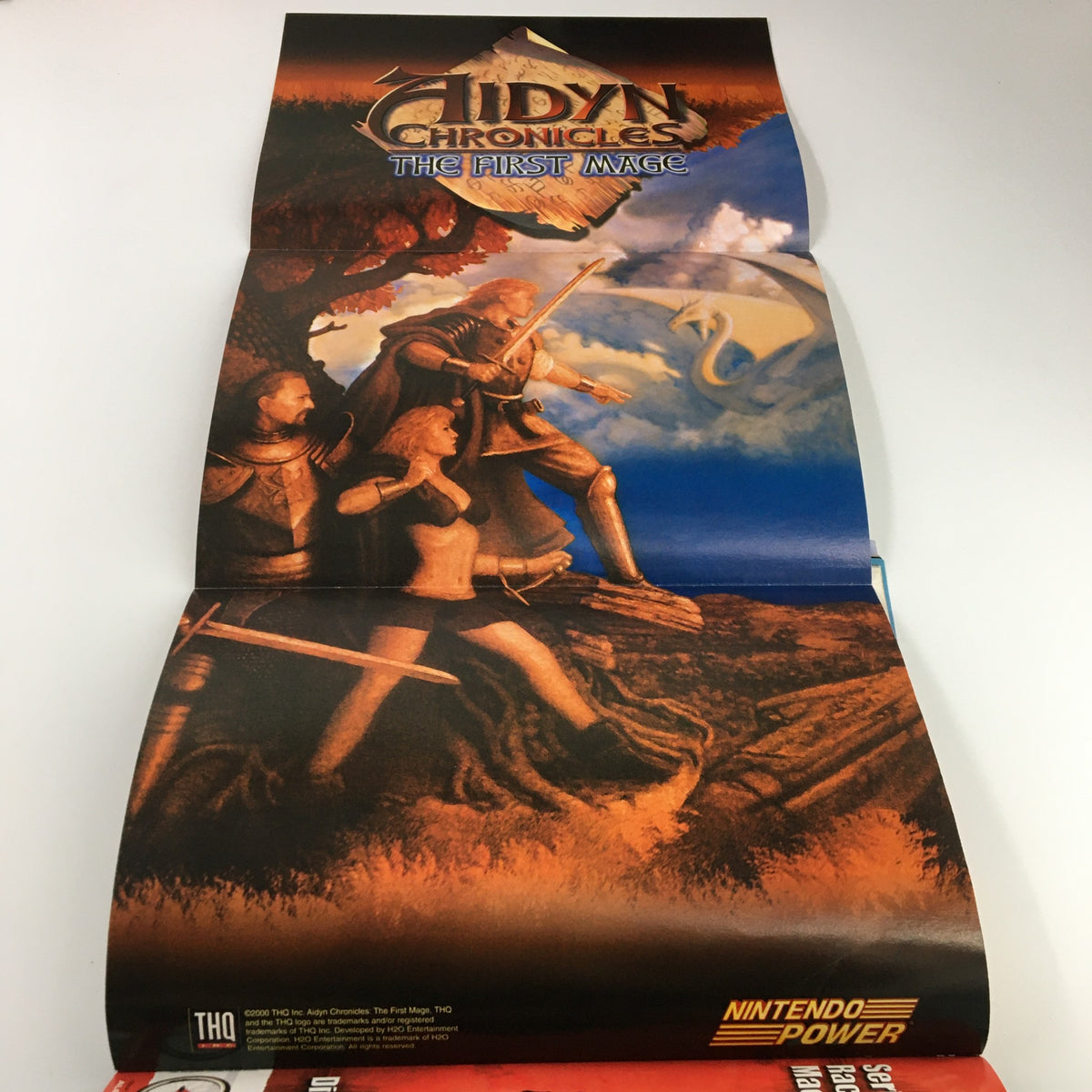 Fold-out poster included in Nintendo Power Magazine Vol. 133 June 2000 featuring artwork from Aidyn Chronicles: The First Mage, showcasing fantasy characters and a dragon.
