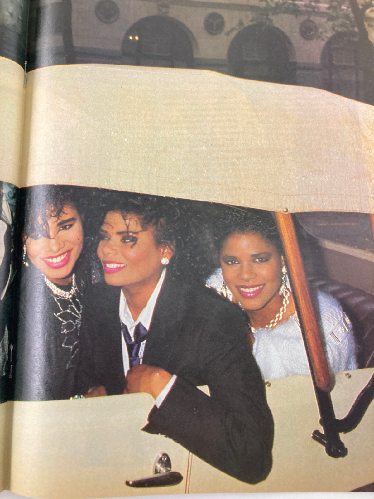 Close-up image from VTG Lookin Magazine September 5 1987, showcasing three fashionable women smiling in a vintage car, reflecting the glamour and trends of the 1980s.