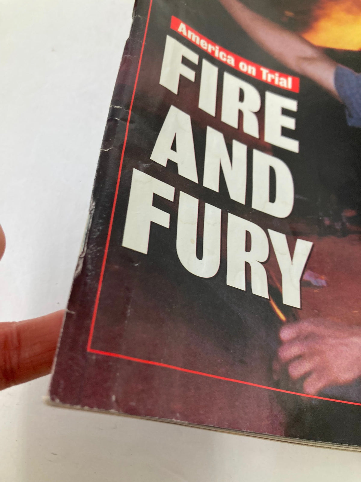 Close-up of the edge of the Newsweek Magazine from May 11, 1992, titled 'America on Trial: Fire and Fury', showing minor wear that adds character.