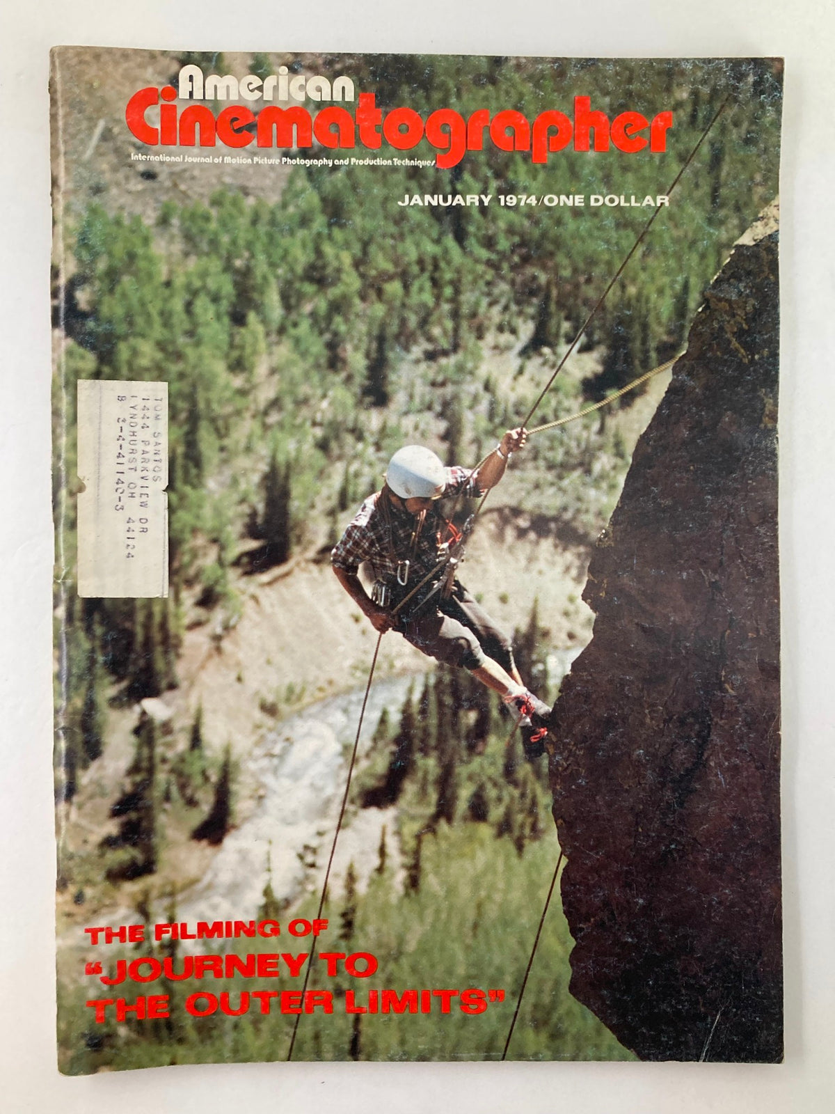 Cover of American Cinematographer Magazine January 1974 featuring the theme 'Journey to The Outer Limits' with a climber rappelling down a cliff.