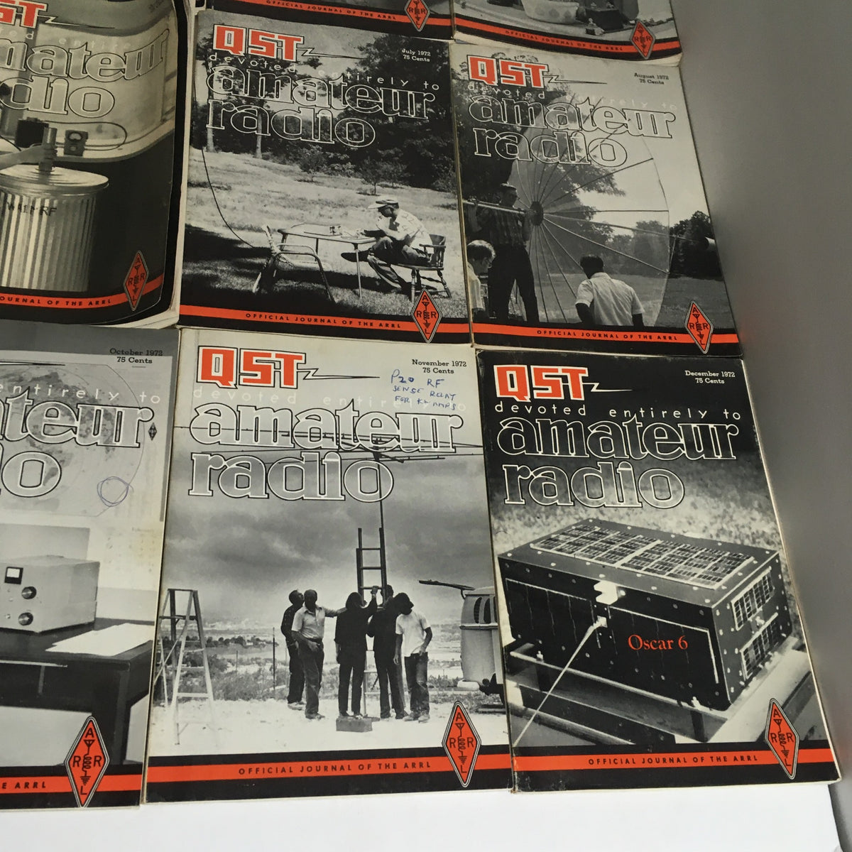 Display of QST Amateur Radio magazine covers from July, August, November, and December 1972, featuring articles and images related to amateur radio. Part of a collection of 12 complete issues for 1972.