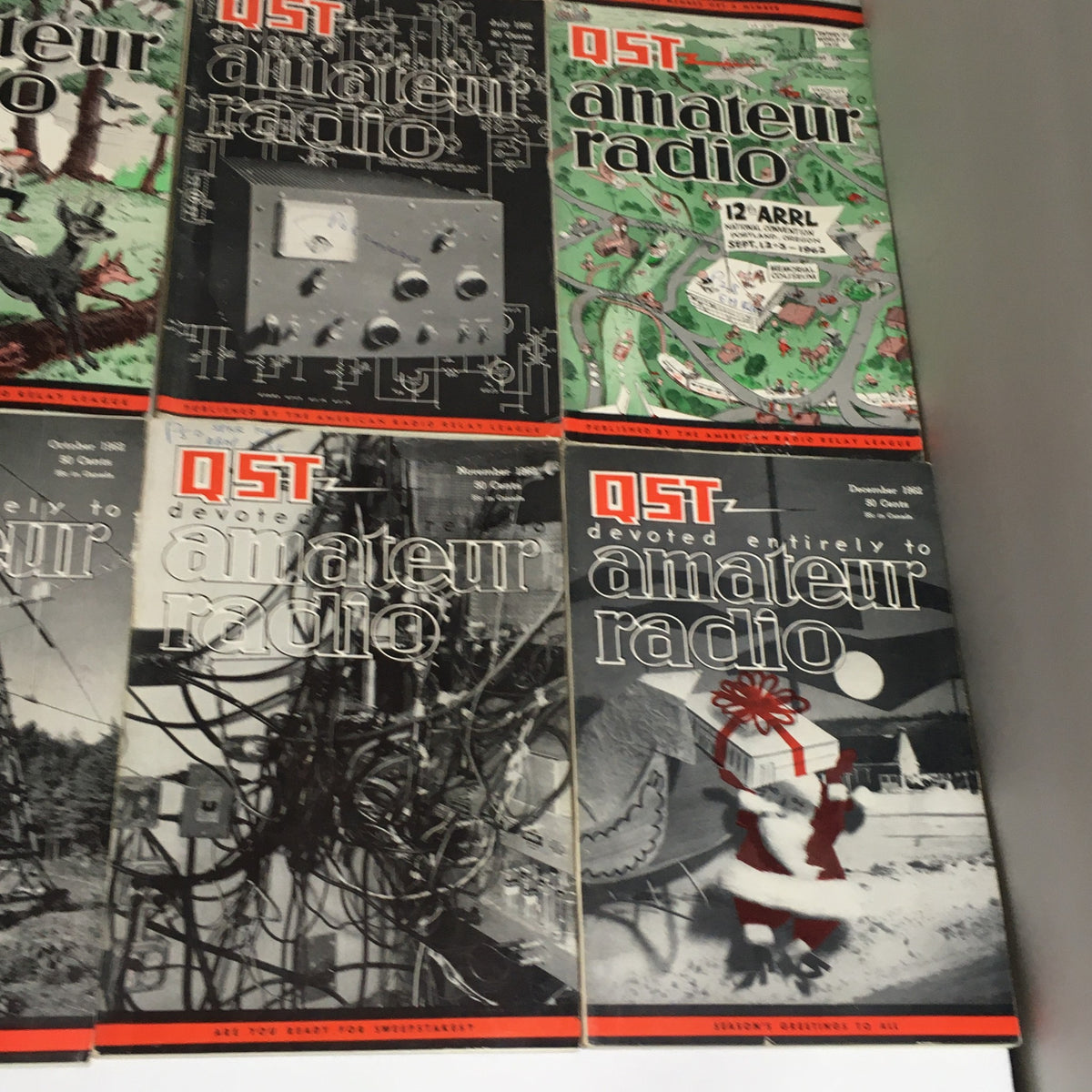 Lot of 12 Complete January to December 1962 QST Amateur Radio displaying covers of December and other notable months, emphasizing historic amateur radio technology.