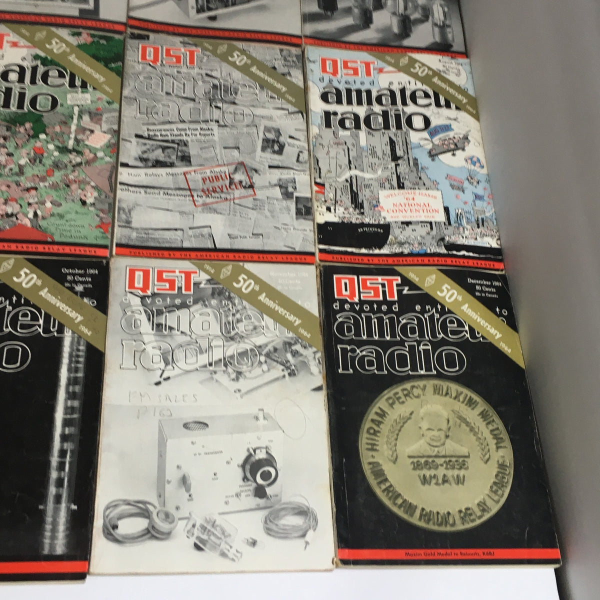 Lot of 12 Complete January to December 1964 QST Amateur Radio magazines, including special anniversary issues with unique graphic designs.