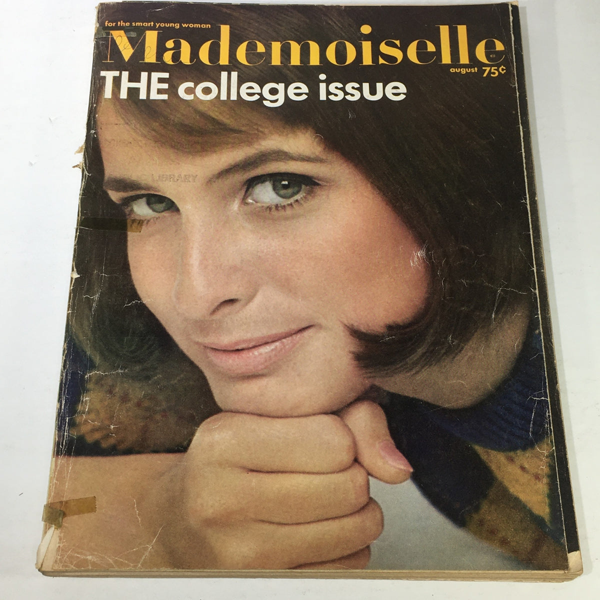 Cover of the VTG Mademoiselle Magazine: August 1965 - The Beautiful College Issue featuring a young woman with a thoughtful expression. The magazine showcases the essence of fashion and beauty from the 1960s, highlighting its retro appeal.