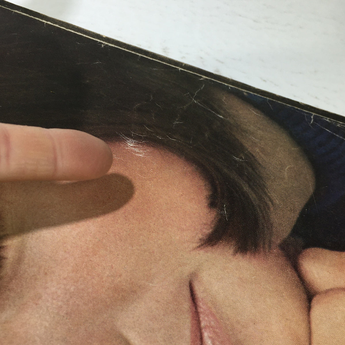 Detail shot of the vintage Mademoiselle Magazine from August 1965, showing a close-up of a model's face on the cover, including signs of wear.