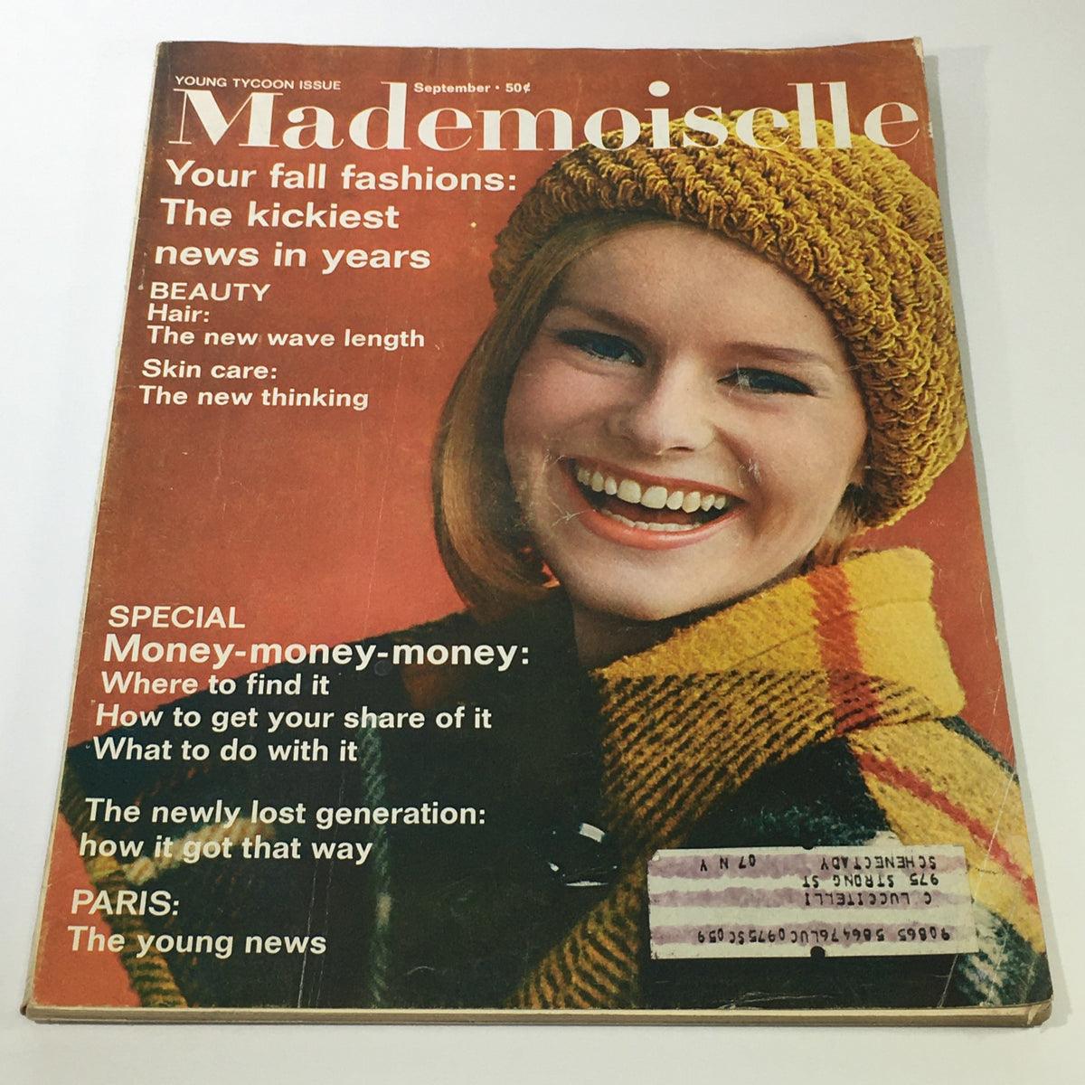 Cover of the VTG Mademoiselle Magazine: September 1964 - Fall Fashion Issue featuring a smiling model in a yellow knit hat, showcasing fall fashion and beauty topics.