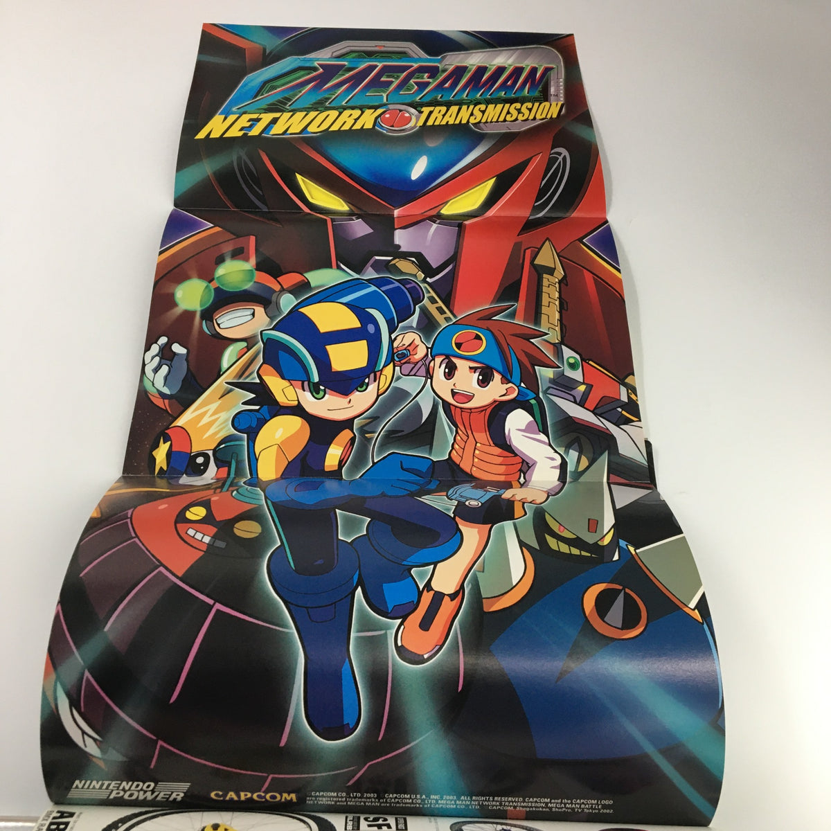 Vibrant poster from Nintendo Power Magazine Vol 169 June 2003, featuring characters from Mega Man Network Transmission.