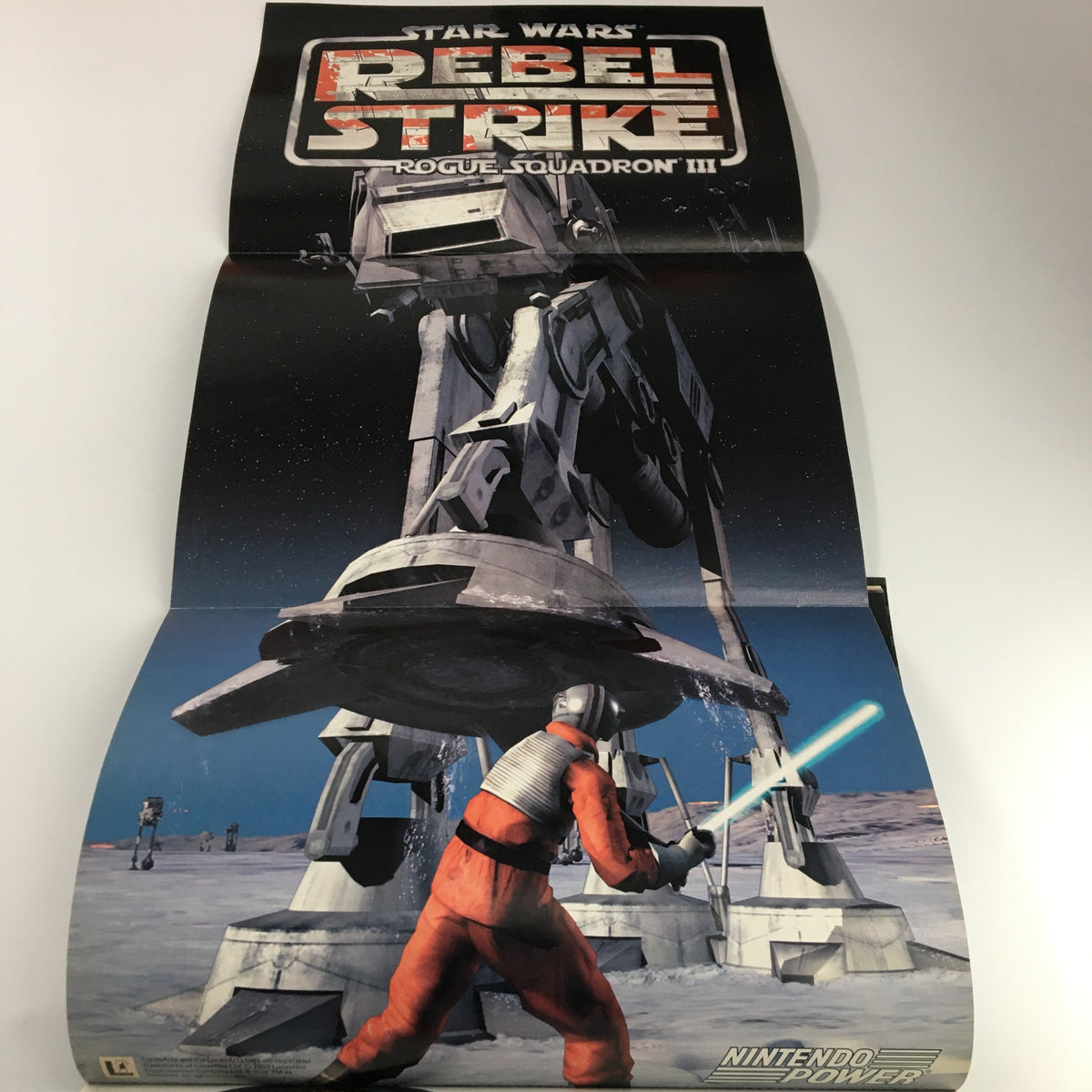 Exclusive poster from Nintendo Power Magazine Vol 172 depicting Star Wars: Rebel Strike with a dramatic scene of a rebel soldier confronting an AT-AT walker.