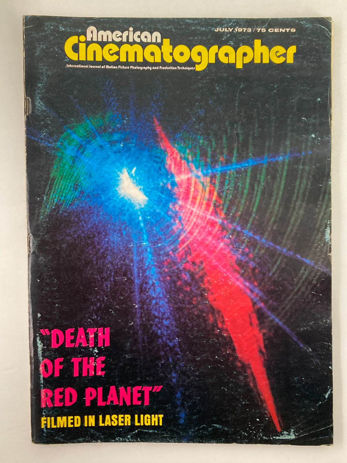 Cover of American Cinematographer Magazine July 1973 featuring the title "Death of the Red Planet" with colorful laser light imagery.