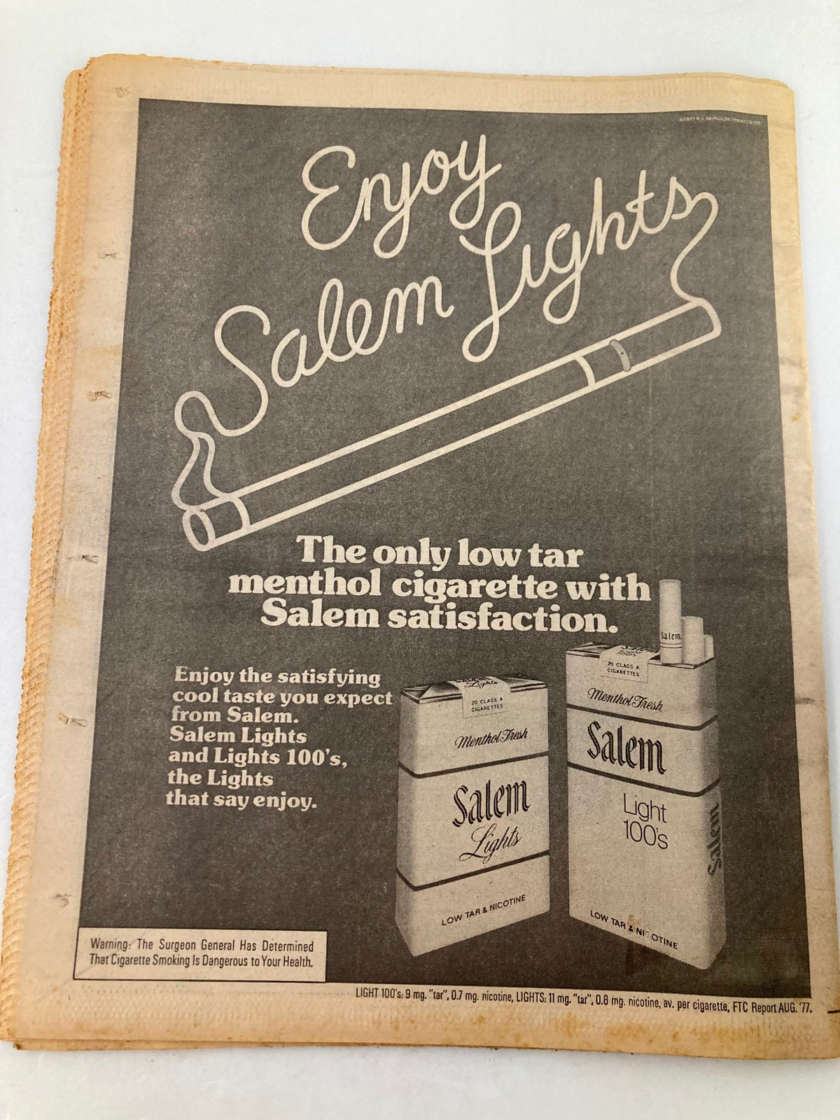 Advertisement for Salem Lights cigarettes from the National Enquirer tabloid, promoting low tar menthol satisfaction with a visual of cigarette packs.